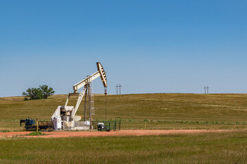 Small oil pump or derrick in field.