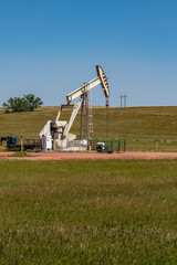 Fototapeta premium Small oil pump or derrick in field.