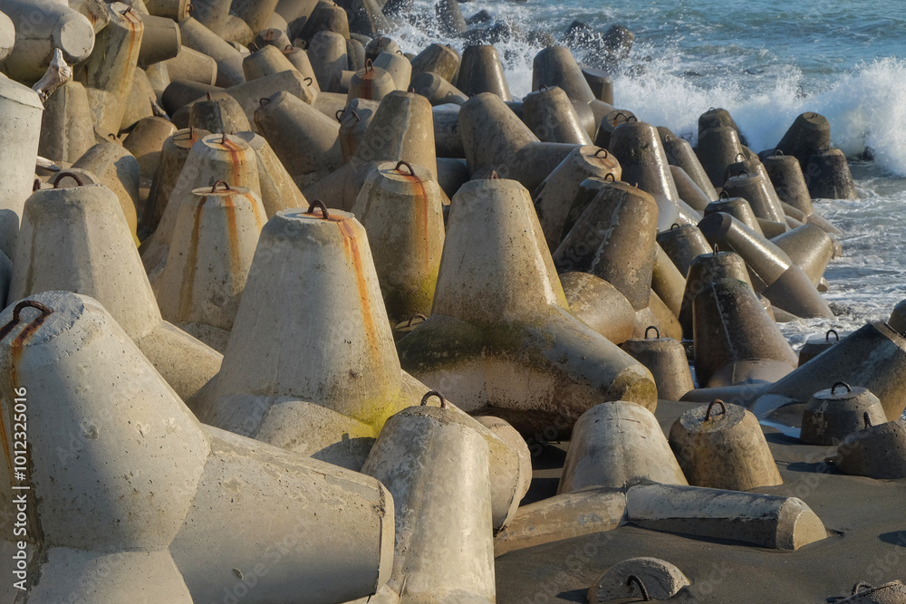 Poster concrete wave breakers on the beach with abstract shapes, patterns and textures. wave breakers to pr
