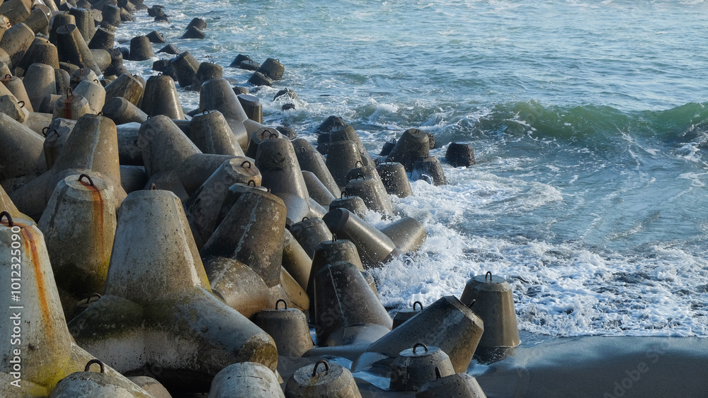 Poster concrete wave breakers on the beach with abstract shapes, patterns and textures. wave breakers to pr