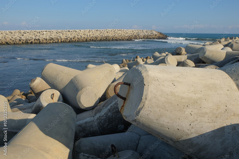 Poster concrete wave breakers on the beach with abstract shapes, patterns and textures. wave breakers to pr