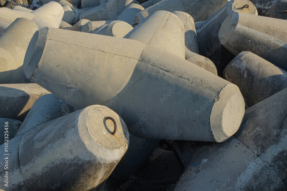 Poster concrete wave breakers on the beach with abstract shapes, patterns and textures. wave breakers to pr