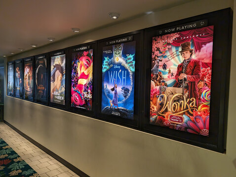 Movie posters lining the wall at Kahala Mall cinema in Honolulu, Hawaii showcasing the latest film releases for visitors to enjoy