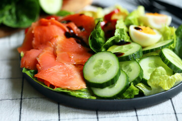 Fresh salad with cucumber, cherry tomatoes and salted salmon