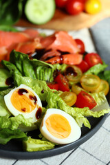 Fresh salad with cucumber, cherry tomatoes and salted salmon