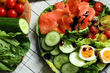Fresh salad with cucumber, cherry tomatoes and salted salmon