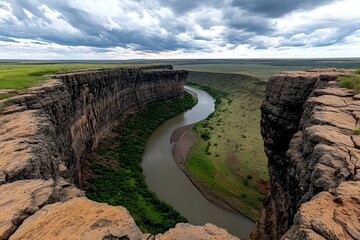 A panoramic shot of the Great Rift Valley, with dramatic cliffs, deep gorges, and a winding river cutting through the valley, capturing the sheer scale of the region