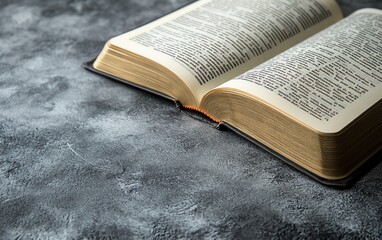 Open holy book on a grey surface with clear copy space banner, perfect for adding quotes or inspirational religious text