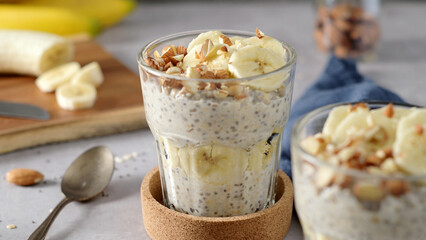 Two bowls of overnight oats topped with banana slices and almonds