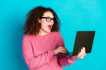 Portrait of nice young girl open mouth laptop wear pink sweater isolated on turquoise color background