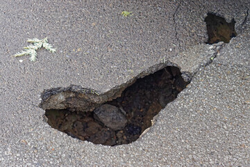 Big and deep sink pot hole at street danger problem