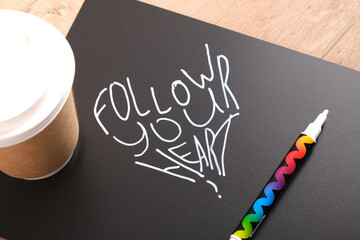 follow your heart inscription on black matte plastic board, motivational slogan concept