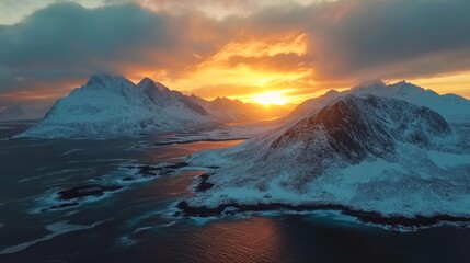 A scenic aerial view of snow-capped mountains and a body of water, with the sun setting behind the mountains, casting a warm glow on the landscape.