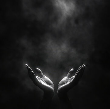 image features two open hands reaching upwards, surrounded by dark, smoky background, evoking sense of hope and yearning