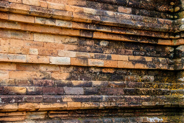 Close-up of aged stone bricks from an ancient temple, showcasing their weathered textures and natural earthy tones