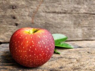 Ripe apple on wood background