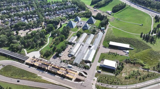 Edmonton, Alberta, Canada, aerial video view, flying around "Muttart Conservatory" a botanical garden in the North Saskatchewan river valley with famous four pyramids and three greenhouses
