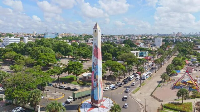 Obelisk in Juan Baron Square and amusement park along Malecon, Santo Domingo in Dominican Republic. Aerial drone orbiting