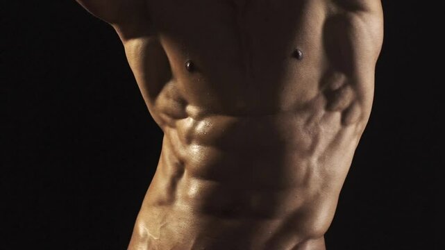 Cropped video of fit man showing six pack abs. Perfect abs, shoulders, and chest. Close up the Abs. Closeup torso. Ab. Muscular torso and ripped abs. Sexy male muscular body.