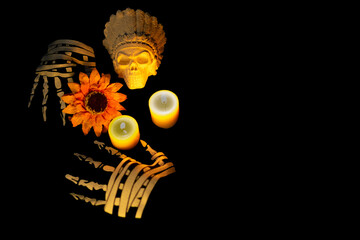 All Souls' Day: bony hands adorning altar with flowers, skull and candles on black background
