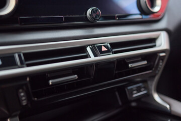 Closeup of car dashboard air vents near gear shift