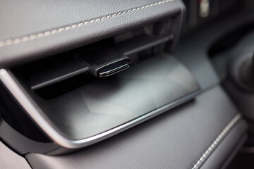 Closeup of car dashboard air vents near gear shift