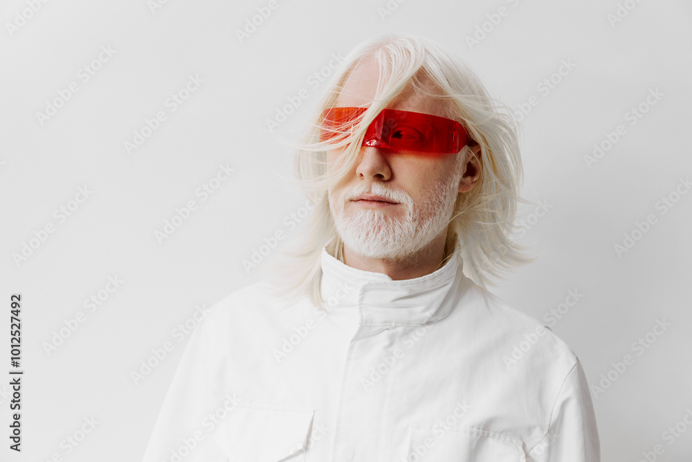 Wall mural stylish elderly man with white hair and red glasses against a minimalist white background, exuding a