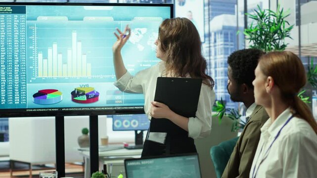 Corporate associates looking into project details and timetables in conference room, establishing budget and operations to accomplish objectives in a competitive business environment. Camera A.
