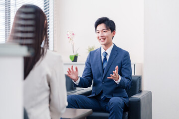 笑顔で得意先と商談をする営業マン © maroke