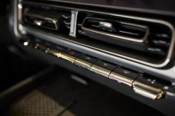 Closeup of car dashboard air vents near gear shift