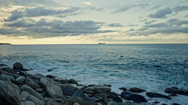 Slow motion of waves breaking on the rocks on a tropical beach at sunset. Macuto Coast, Venezuela.