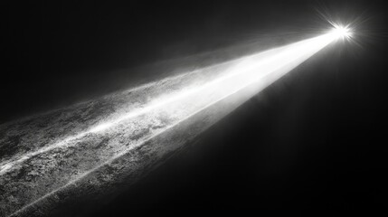 A single intense beam of white light piercing through a pitch-black background, creating sharp contrasts and glowing edges. The light scatters slightly as it moves forward.