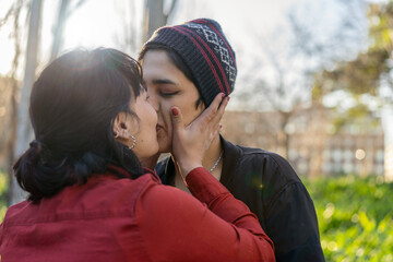 Young woman planting a sweet kiss on her girlfriend's lips