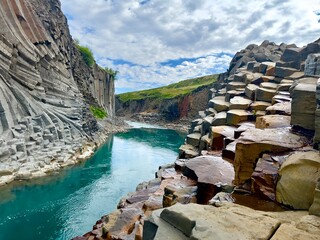 Canyon with green blue river in Iceland Rocky formations 