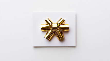 Elegant golden bow placed on a plain white background for Christmas Day celebrations