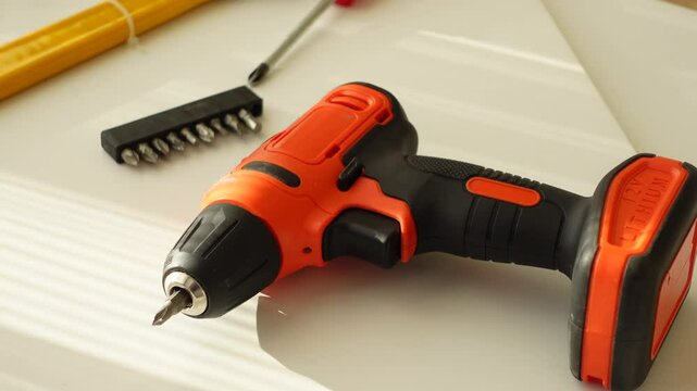 DIY tools and materials are arranged on a wooden floor, illuminated by natural light