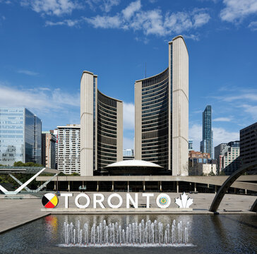 TORONTO, CANADA - OCTOBER 04, 2024: Toronto sign and New City Hall at Nathan Phillips Square in Toronto in a sunny day, Ontario, Canada