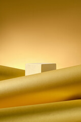 The image presents a white platform for product display, contrasting with the soft curves of golden...
