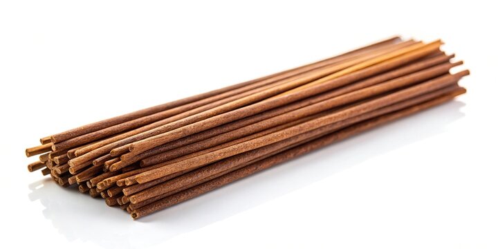 Forced perspective of brown agarbatti or incense sticks isolated on white background