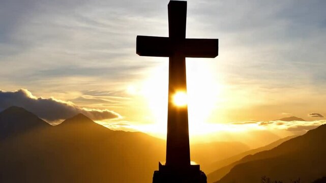 Christian cross in the glow of the sun, mountain landscape above the clouds