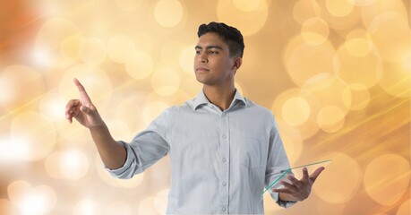 Man holding a futuristic digital tablet touching invisible screen against spots of light