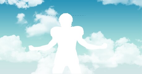 Silhouette of a male rugby player against clouds in the blue sky with copy space