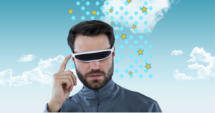 Caucasian man wearing vr googles against clouds in blue sky with copy space