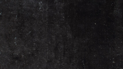 The background is made of an old worn, gray-black surface