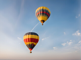 Hot air balloon in flight against the sky. Hot air balloons are aircraft that gain their lift by heating a large contained envelope of air above the ambient temperature