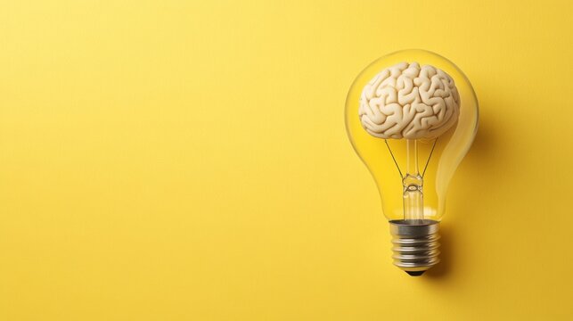 A light bulb with a brain inside symbolizes innovative thinking and creativity against a vibrant yellow background.