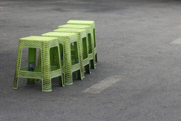 Green plastic chair on the street