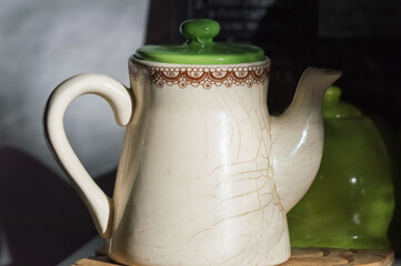 Ceramic teapot on a wooden board in the kitchen