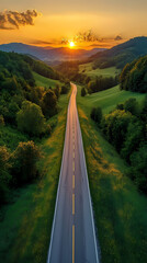 Fototapeta premium Top drone view of road in woods. Beautiful landscape with roadway in hills, pine trees, meadows, golden sunlight in fall. Travel