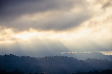 Sun Rays Over Misty Mountains
